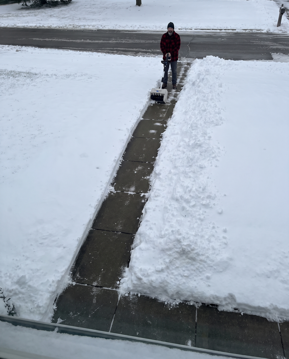 A cleared path through the snow from the front door to the street